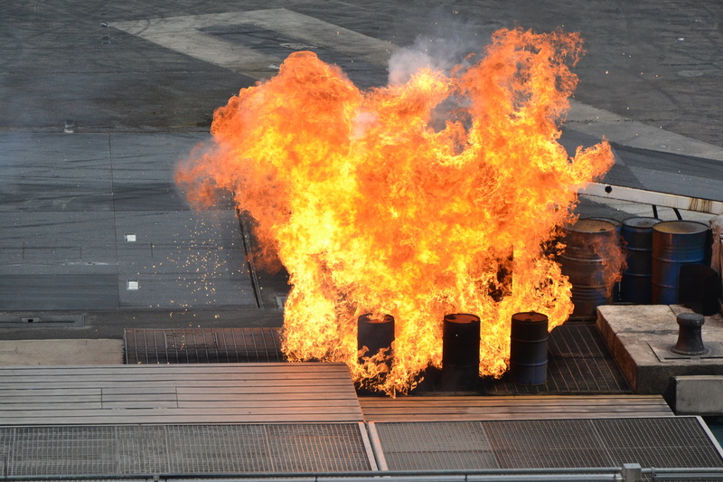 container, nature, sign, orange color, darting flame, hot, built structure, motion, glowing, architecture, warning sign, red, no people, stunt show, danger