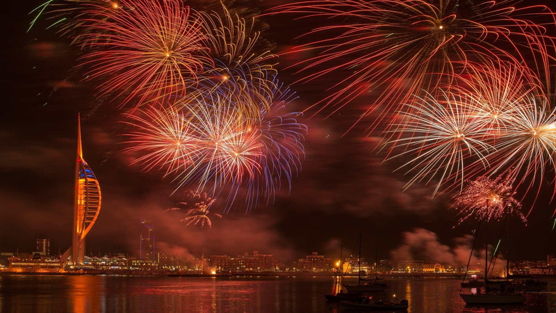 outdoors, firework display, event, no people, night, portsmouth, skyscraper, fireworks, cityscape, water, sparks, illuminated, built structure, europe