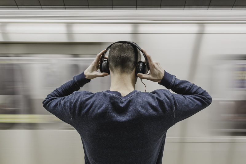 headphone, real people, indoors, people, adult, leisure activity, public transportation, 4K, front view, standing, sweatshirt, gray, train, arms raised