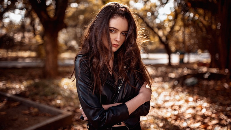 looking, hair, one person, hairstyle, long hair, looking at viewer, leather, arms crossed, outdoors, focus on foreground, fashion, women outdoors, contemplation