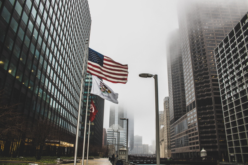 low angle view, cityscape, windows, corporate, flag, low angle shot, financial district, outdoors, downtown, fog, tall - high, travel destinations, architectural design