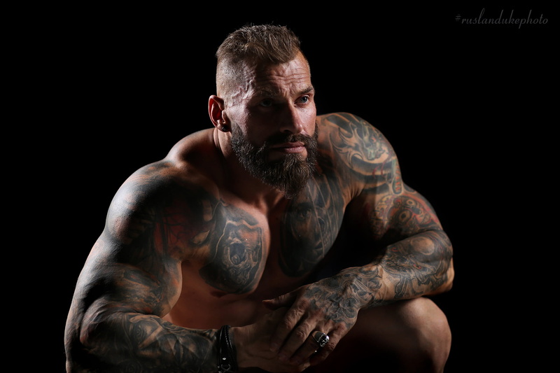 rings, looking away, muscular, blue eyes, short hair, simple background, 1080P, black background, men, beard, shaved head, Ruslan Duke, tattoo