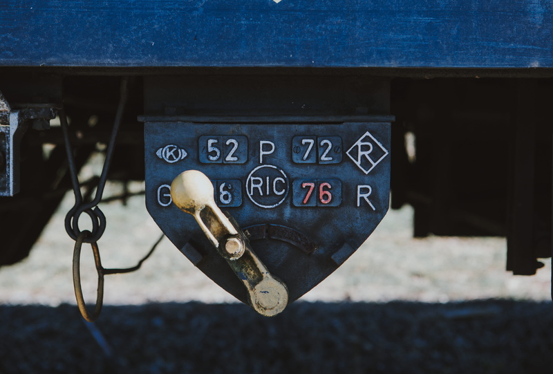 blue, rust, communication, security, number, machinery, lock, outdoors, wheel, cowbell, western script, letterbox, ball, day, focus on foreground, no people