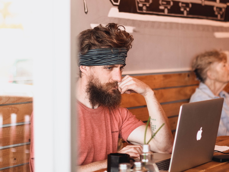 male, focusing, cafe, work, facial hair, wireless technology, tattoo, using laptop, sitting, office, casual clothing, indoors, working, men, adult, hipster - person