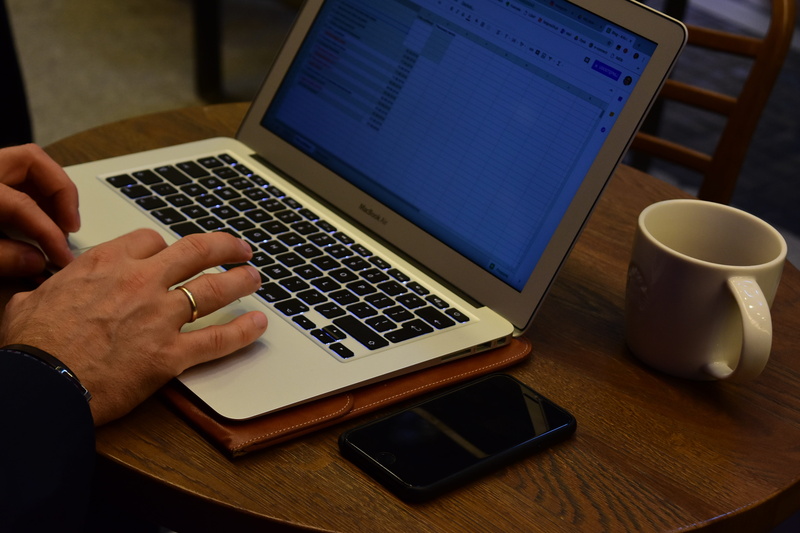 technology, surfing the net, coffee, writing, communication, cup, real people, computer, human hand, hand, table, indoors, phone, guy, human body part