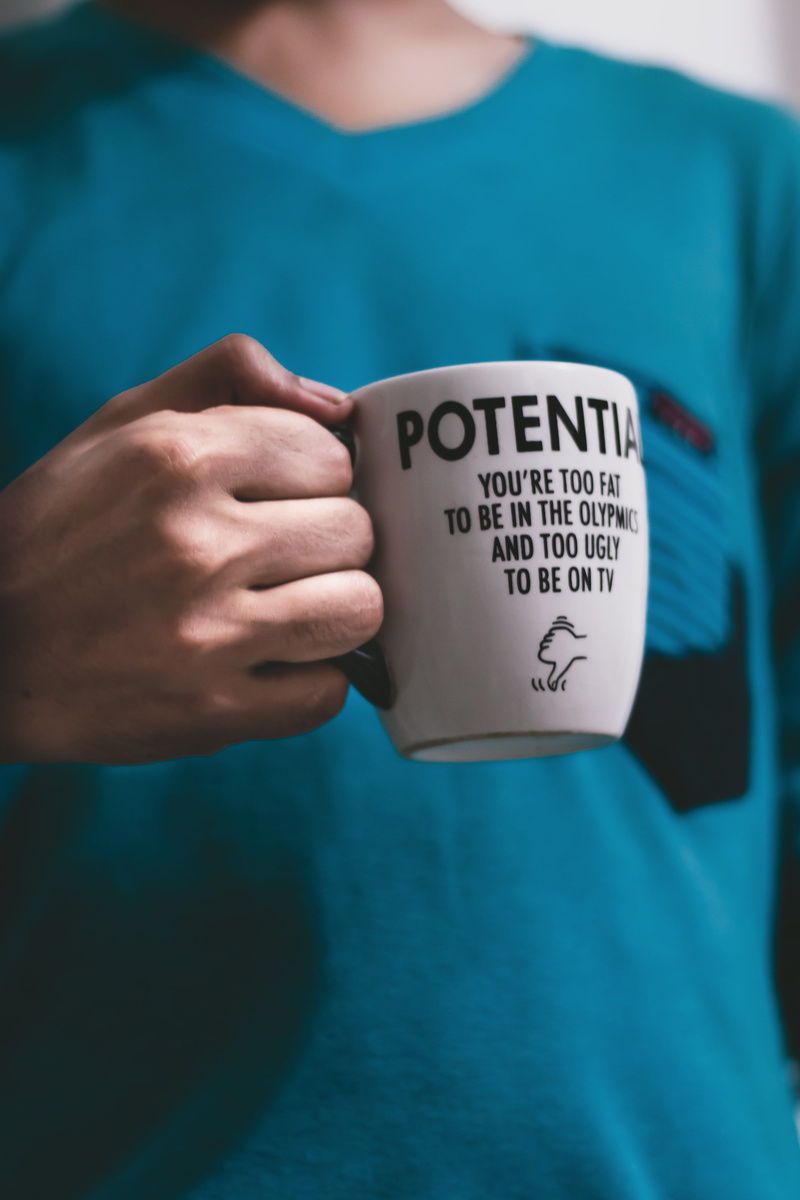 communication, shirt, text, casual, holding, photoshoot, human body part, real people, young man, pose, standing, coffee cup, human, wear, lifestyles, person