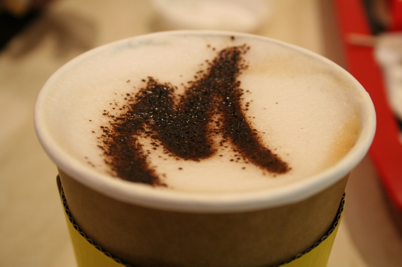 cup, mug, coffee, indoors, drink, tea, non-alcoholic beverage, mcdonalds, frothy drink, letter m, no people, still life, blur, mocha, table, coffee cup