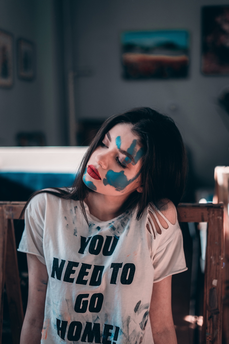 hair, waist up, leisure activity, furniture, front view, apparel, teenager, young adult, face paint, t-shirt, hat, real people, undershirt, lifestyles