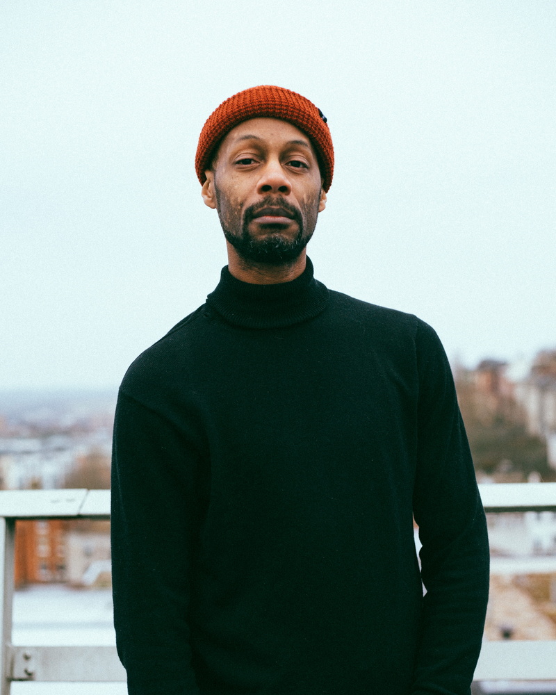 focus on foreground, modern wear, hat, african american, waist up, knitted, turtle neck, young men, lifestyles, black, warm clothing, architecture, knit