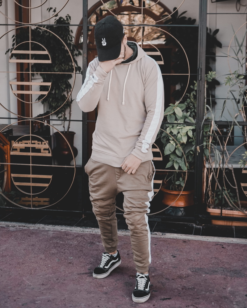 person, architecture, cap, hat, man, casual clothing, right, day, covering, lifestyles, face, young adult, hand, metal, building exterior, real people