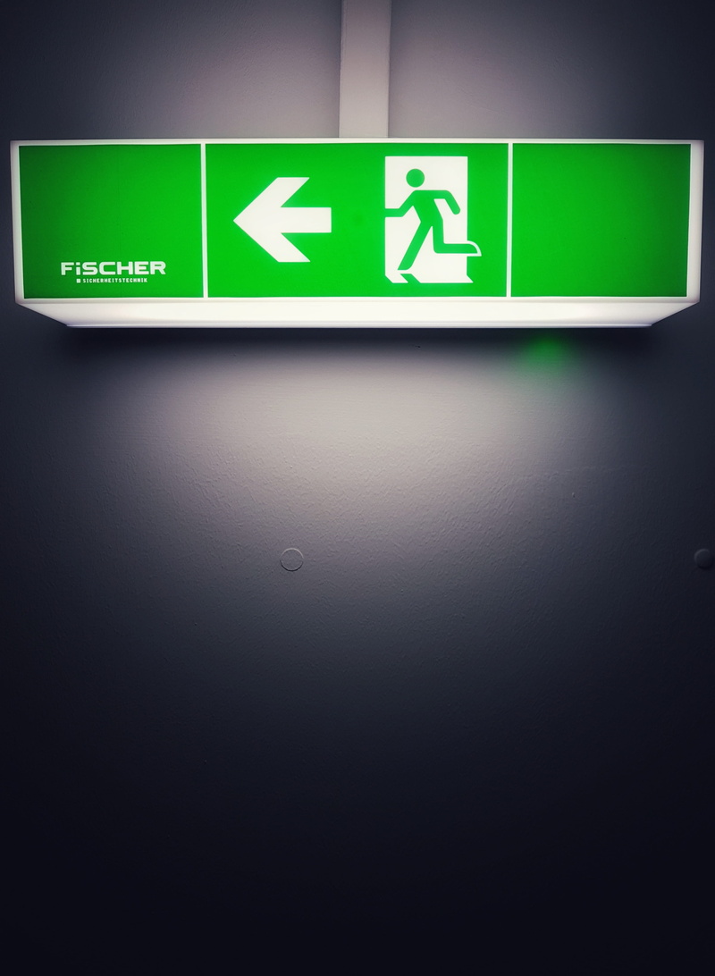direction, close-up, road, communication, wall, arrow symbol, text, exit, wall - building feature, arror, guidance, safety, fire, symbol, fischer, information