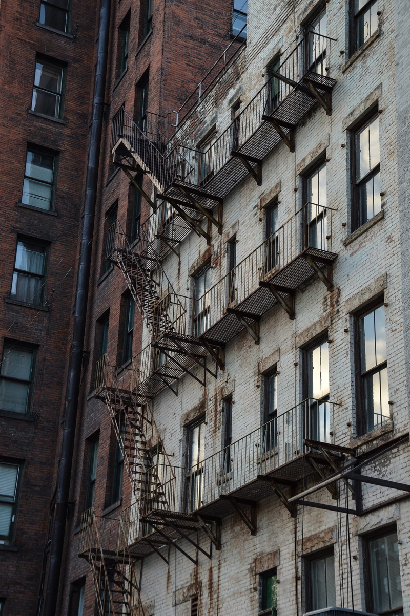 city, facade, downtown, urban, low angle view, apartment, outdoors, backgrounds, built structure, residential, property, building exterior, residential district