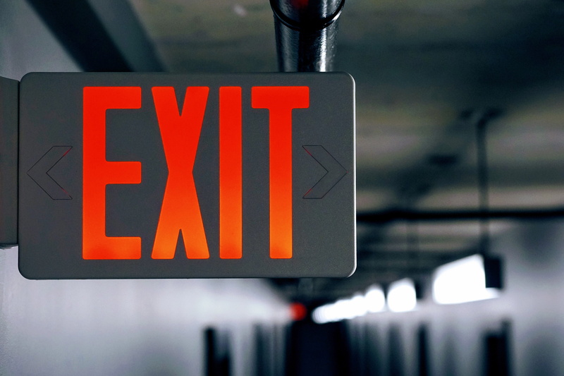 directional sign, illuminated, indoors, exit, message, urban, direction, black color, text, safety, no people, focus on foreground, western script, arrow symbol