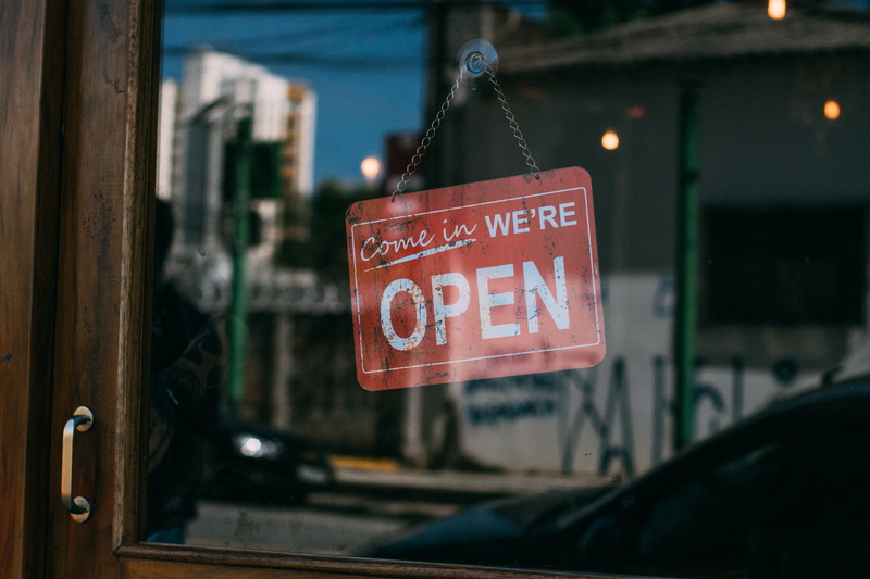 no people, indoors, focus on foreground, graffiti, shop, text, close-up, capital letter, hanging, transparent, city, car, business, transportation system