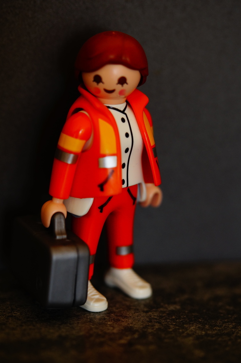 paramedic, indoors, art and craft, human representation, work clothes, front view, supply, black background, childhood, emergency, ambulance, focus on foreground
