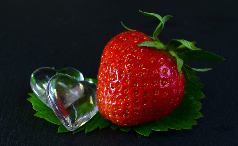 food and drink, still life, leaf, fruit, red, group of objects, sweet, healthy, strawberries, freshness, studio shot, summer, berry fruit, heart, juicy
