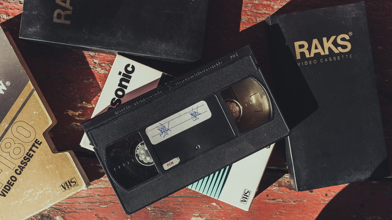 communication, retro styled, western script, black color, vhs, still life, 2K, text, stack, indoors, no people, photography themes, film industry, camera - photographic equipment