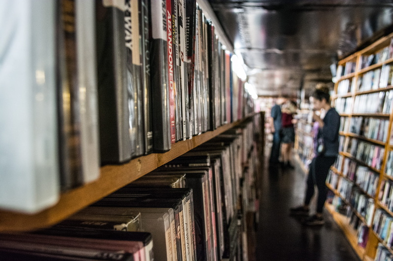 adult, building, director, studying, architecture, vhs, publication, in a row, shelf, people, movies, actor, date night, university, library, indoors, two people
