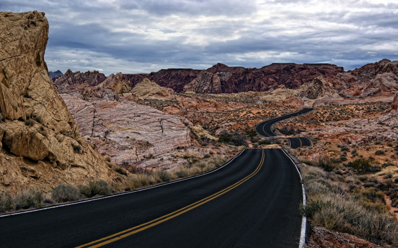 road, landscape, rock, outdoors, mountain, nature, beauty in nature, road marking, diminishing perspective, cloud - sky, dividing line, no people, solid