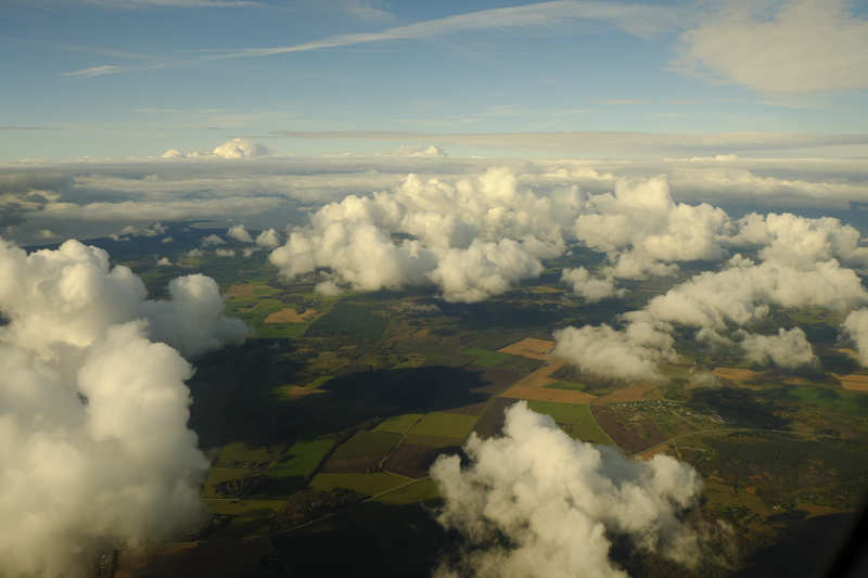 high, altitude, photography, tranquility, non-urban scene, cloud - sky, daytime, field, clouds, flying, smoke - physical structure, tranquil scene, environment