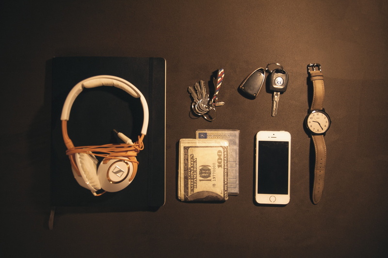 wireless technology, indoors, smart phone, high angle view, black background, near, headphones, communication, choice, money, clock, mobile phone, leather