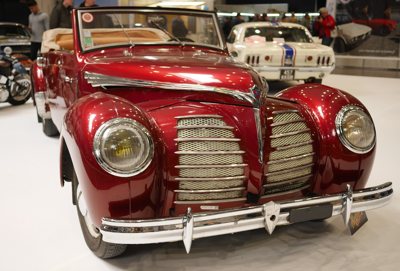 focus on foreground, close-up, retro styled, no people, car collection, 4K, day, calender, vintage car, land vehicle, shopping, red, headlight, indoors