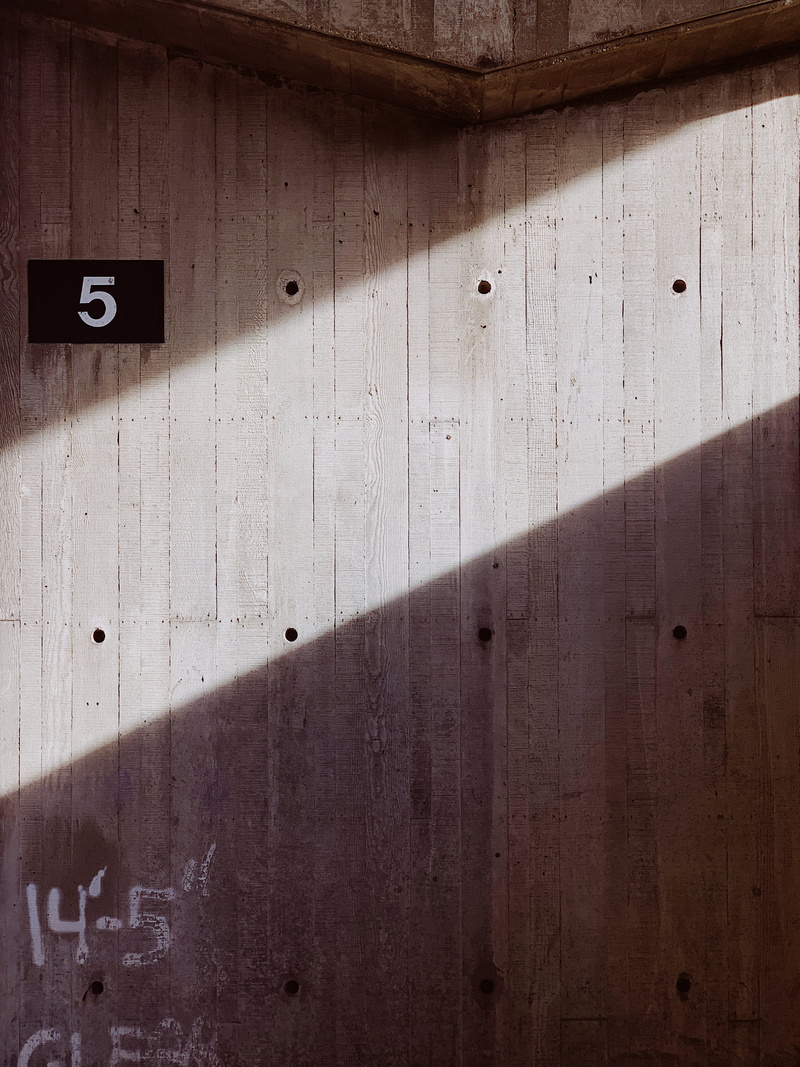 clothing, coat, indoors, concrete, apparel, floor, light, close-up, wood - material, architecture, overcoat, wood, tire, sunlight, communication, sign