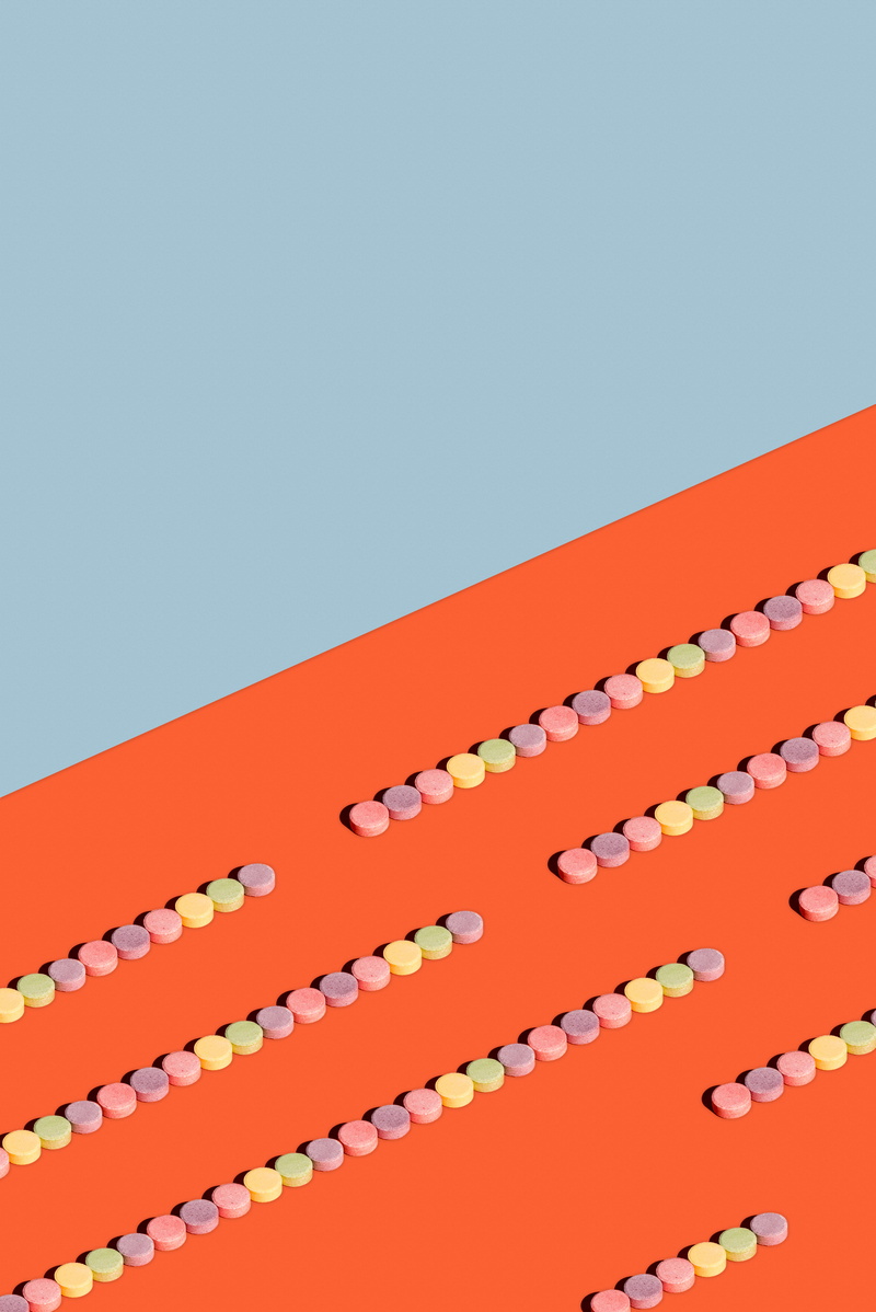 low angle view, copy space, architecture, hanging, minimal, pills, studio shot, multicolored, group, design, clear sky, lollies, day, built structure, piled