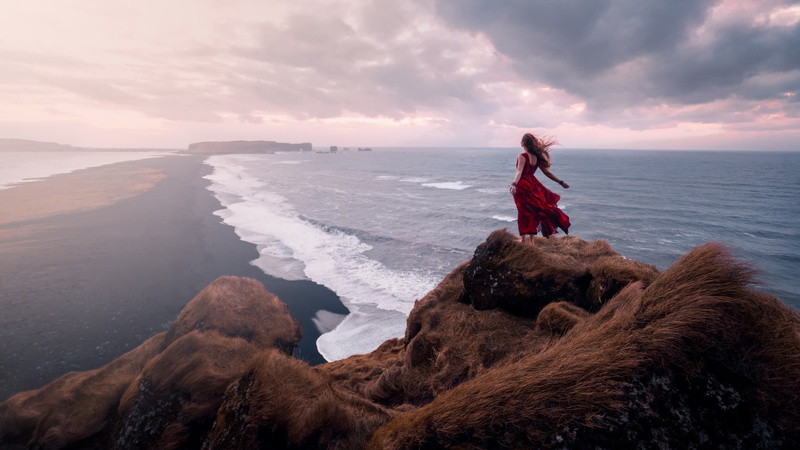 outdoors, beauty in nature, rear view, land, scenics - nature, windy, leisure activity, red dress, looking at view, lifestyles, adult, long hair, cliff