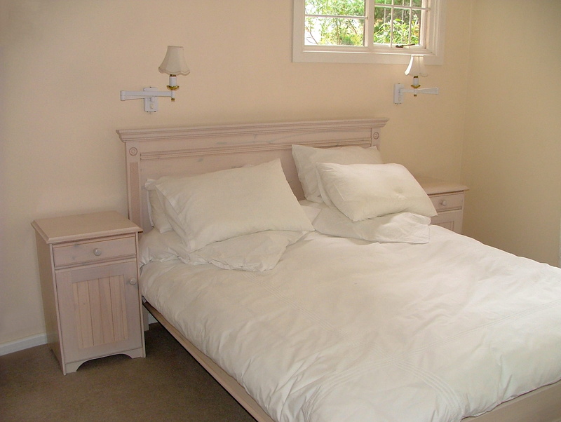 home showcase interior, no people, night table, neat, bed, home, white pillows, day, furniture, white color, 2K, home interior, luxury, comfortable, bedside tables