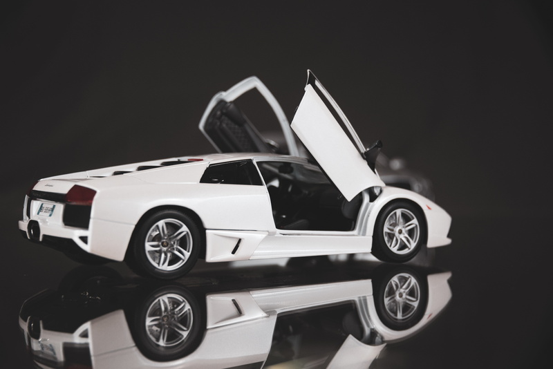 indoors, wheel, car, land vehicle, spoke, luxury, vehicle, sports car, black background, still life, studio shot, alloy wheel, close-up, race car, car wheel