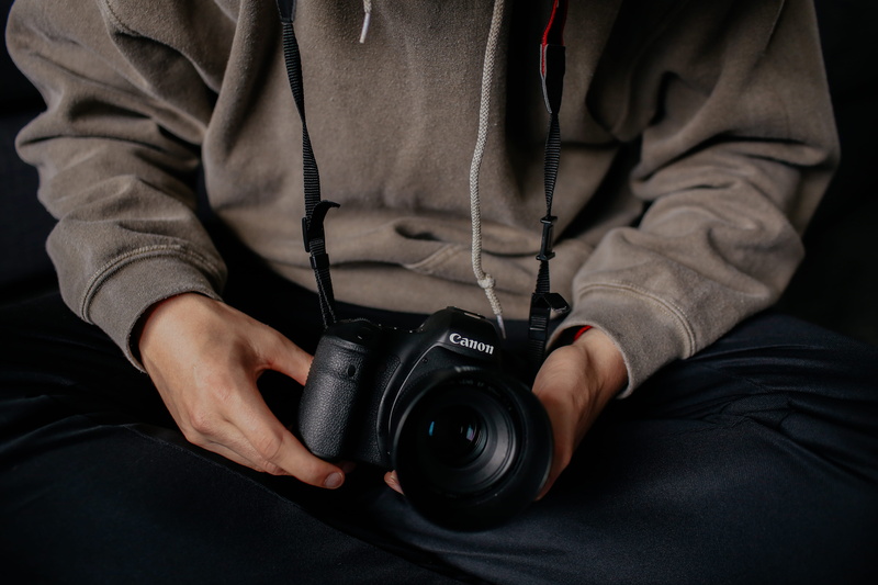 midsection, technology, lens - Optical Instrument, camera - Photographic Equipment, camera, casual clothing, one Person, indoors, hand, front view, digital Camera