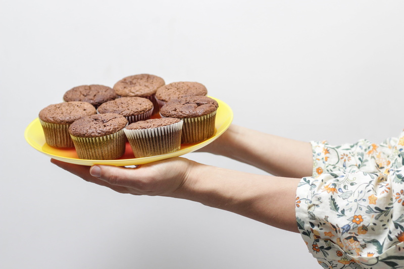 people, eat, food and drink, only women, one person, cupcake, indoors, temptation, chocolate, decor, white, event, muffin, wall, still, white background
