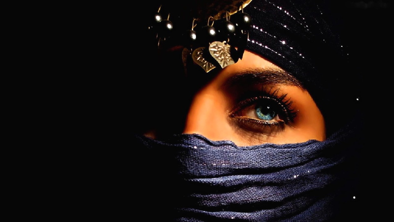 black background, studio shot, decoration, human eye, headdress, obscured face, beautiful woman, looking at camera, young women, s, adult, human face, portrait