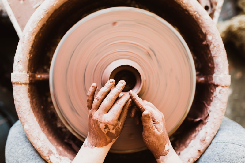 craft, shape, create, molder, finger, person, outdoors, one man only, 5K, clay pot, dirty, holding, day, focus on foreground, working, turning, one person