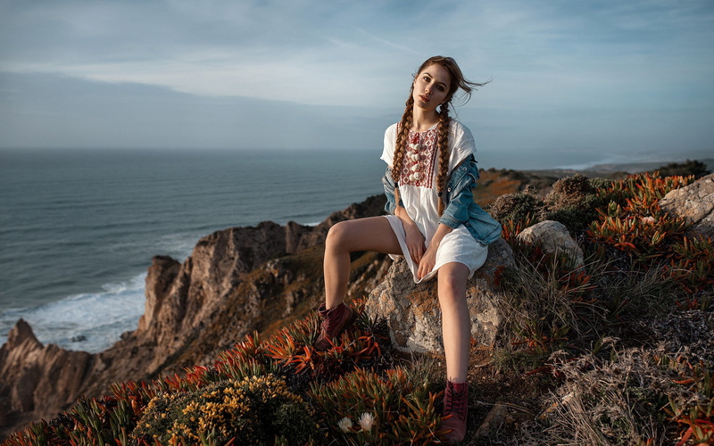 horizon, sitting, model, on the shore, brown hair, braids, 1080P, stones, makeup, sea, Ksenia Kokoreva, hairstyle, rocks, shoes, pose, dzhinsovka, dress