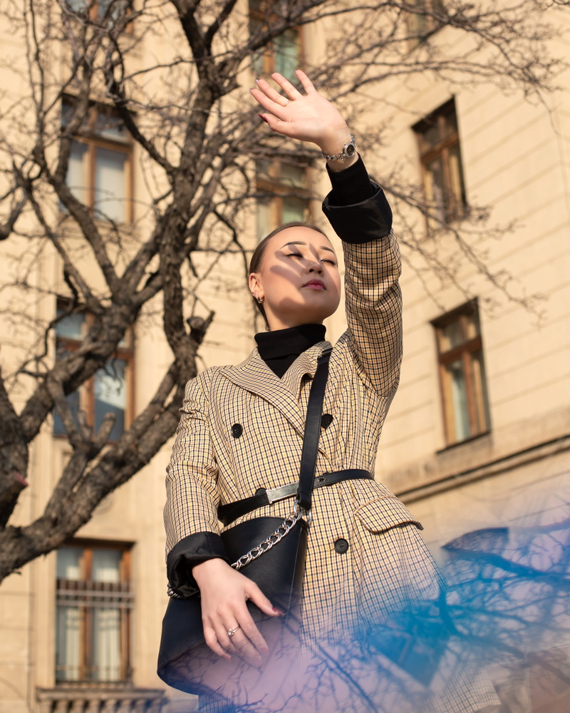 leisure activity, day, casual clothing, handrail, building exterior, architecture, breasted, overcoat, human arm, looking, kazakhstan, sun, waist up, coat