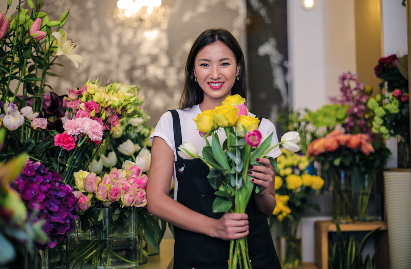 adult, nature, standing, florist, flower arrangement, plant, store, outdoors, beauty in nature, bouquet, smiling, sales occupation, hairstyle, portrait
