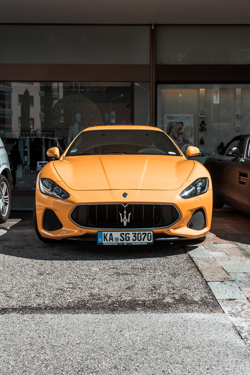 motor vehicle, human, monaco, vintage car, transportation, 5K, wheel, building exterior, taxi, automobile, machine, car wheel, yellow taxi, outdoors, car