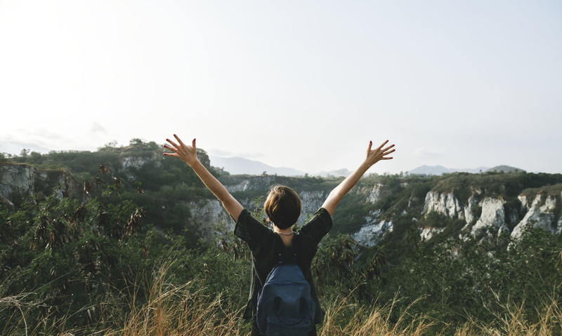 lifestyles, mountain, freedom, positive emotion, standing, nature, one person, rear view, sky, limb, real people, human limb, carefree, wood, leisure activity