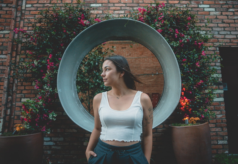 person, female, tattoo, pot, architecture, flower, one person, outdoors, built structure, leisure activity, beauty, young adult, adult, standing, jar, united states