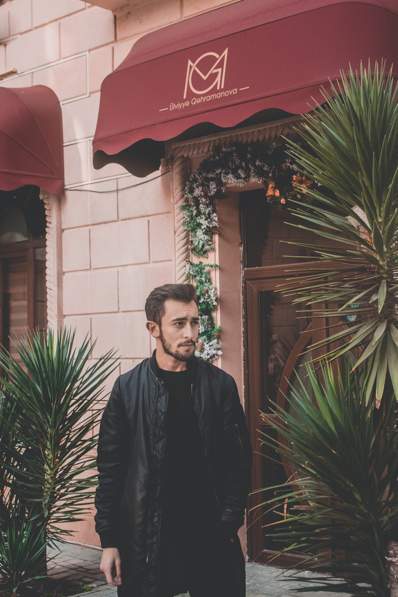 canopy, awning, beside, man, wearing, apparel, day, porch, young adult, coat, agavaceae, architecture, jar, nature, home decor, jacket, tree, waist up