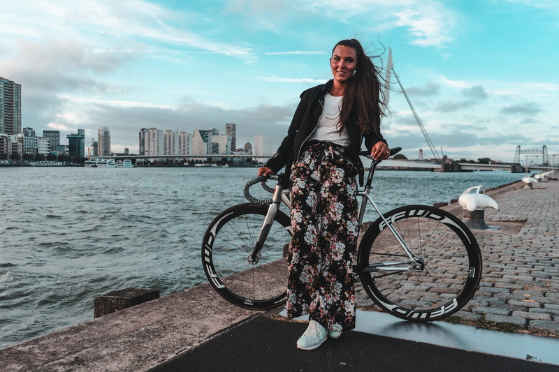 potted plant, architecture, mode of transportation, jar, one person, woman, vase, young adult, lifestyles, shoe, transportation, land vehicle, cloud - sky