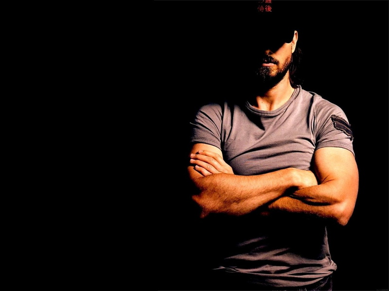lifestyles, front view, facial hair, casual Clothing, backgrounds, mid adult men, adult, gray, men, indoors, neck, t, muscular Build, arms crossed, dark