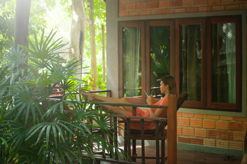 warm, chilled, chair, adult, contemplation, tree, mobile phone, travel, sitting, sun, plam trees, room, seat, plant, woman, holiday, nature, cellphone