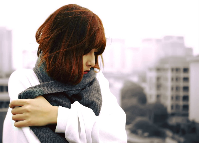 scarf, waist up, cityscape, lifestyles, fashion, weather, holding, architecture, skyscraper, adults only, cold, young adult, people, one person, looking