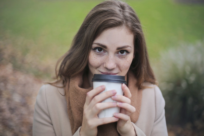 blurred background, women, coffee cup, black, one person, wear, brown hair, travel, lady, white, looking at camera, person, close -up, adult, headshot