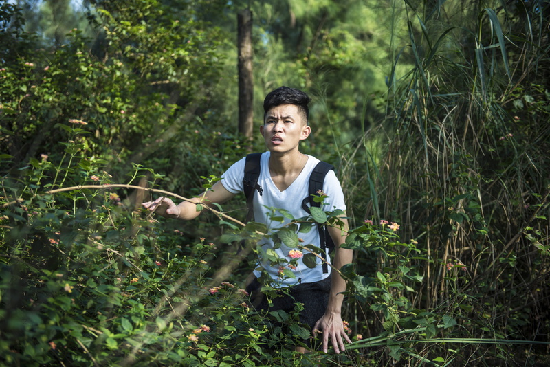 real people, lifestyles, day, holding, get lost, growth, schoolboy, front view, green color, land, plant, leisure activity, tree, looking away, three quarter length