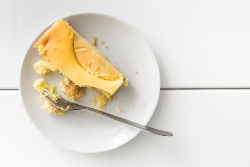 fork, no people, white, slice, indulgence, crockery, plate, sweet food, bake, dairy product, above, sweet, yellow, cheese, pie, gourmet, beside, cheesecake