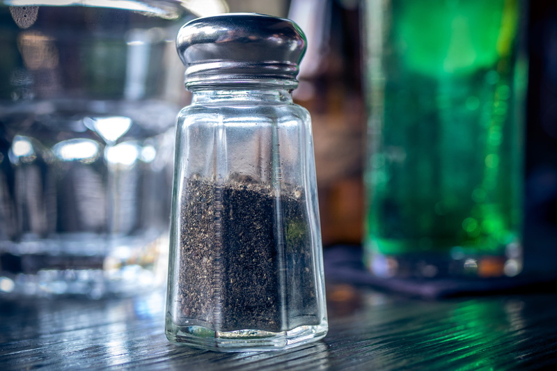 table, indoors, selective focus, no people, pepper shaker, salt - seasoning, 5K, jar, spice, pepper, wood - material, glass - material, focus on foreground